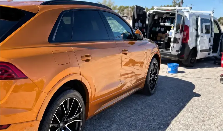 Orange SUV receiving mobile detailing service in El Paso