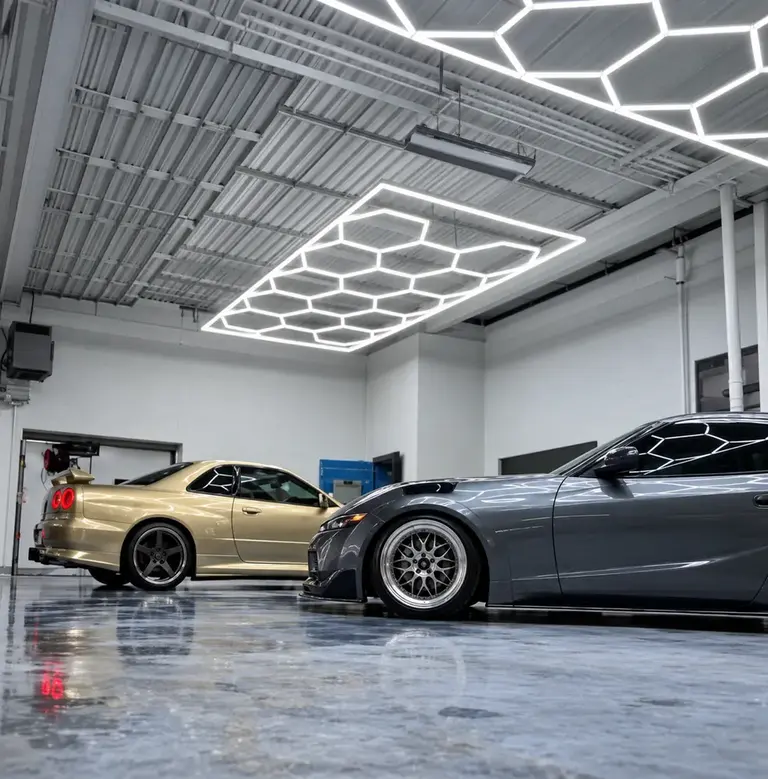 Two detailed performance cars inside the Reality Auto Detailing shop